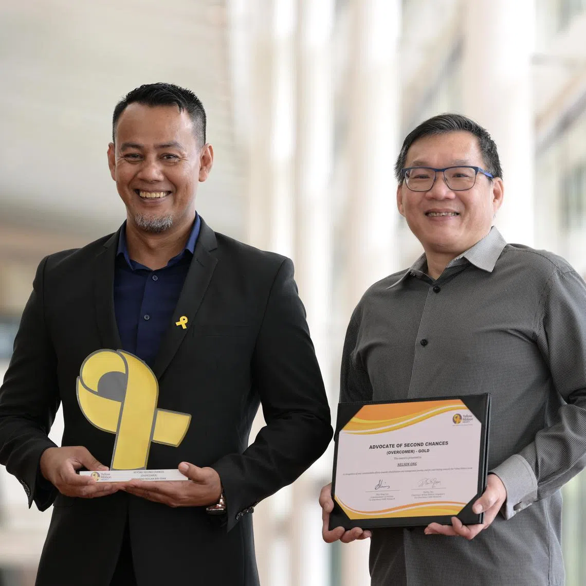 Mr Nelson Ong (left), Senior Manager (Skills@YR), Yellow Ribbon Singapore and recipient of Advocates of Second Chances and Dr Mohammad Riduan Ishak, Executive Director, Tarkiz Pte Ltd and recipient of Beyond Second Chances.