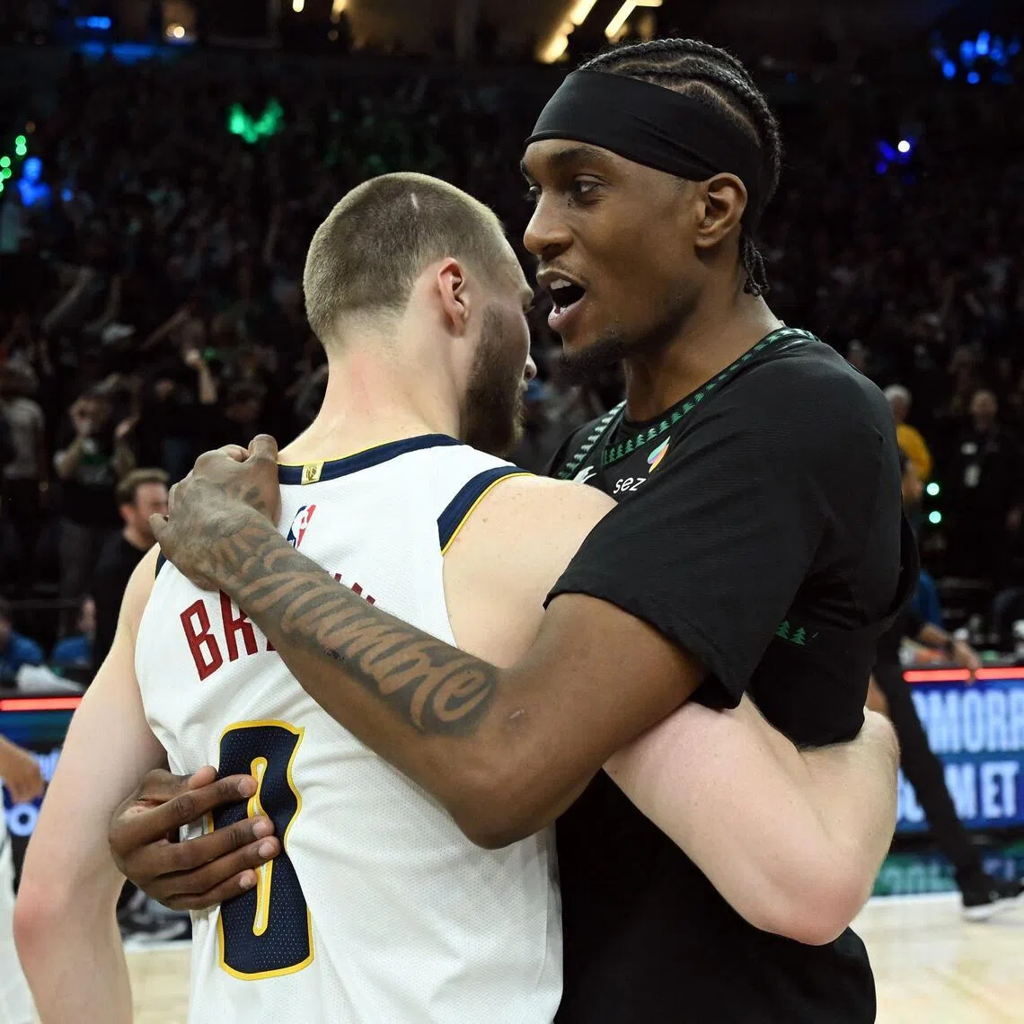 Jaden McDaniels (right) of the Minnesota Timberwolves embracing the Denver Nuggets' Christian Braun after Minnesota's 110-98 win on April 30.