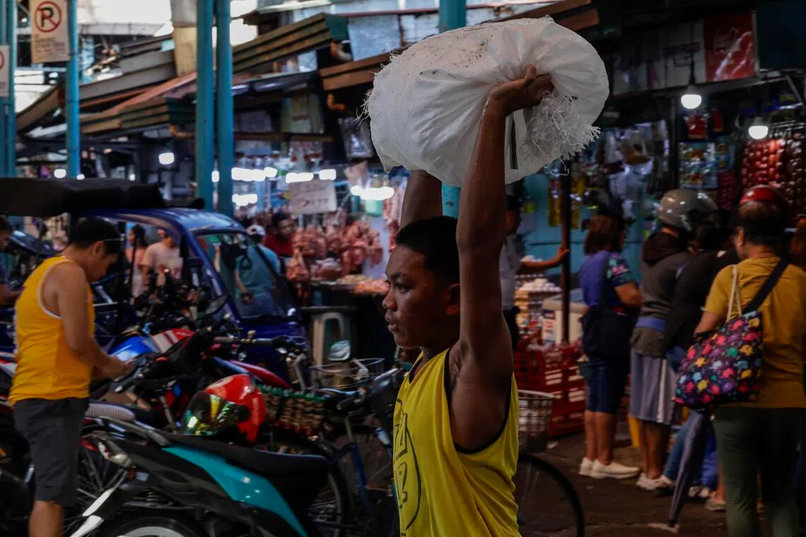 A vendor carries a sack of ice at a market in Marikina City, Metro Manila, Philippines, 05 May 2026. 