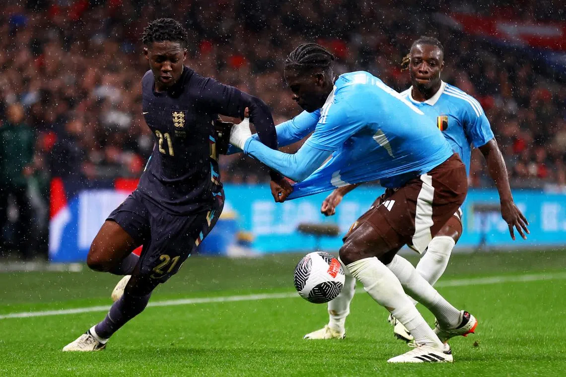 Soccer Football - International Friendly - England v Belgium - Wembley Stadium, London, Britain - March 26, 2024 England's Kobbie Mainoo in action with Belgium's Amadou Onana and Jeremy Doku Action Images via Reuters/Matthew Childs