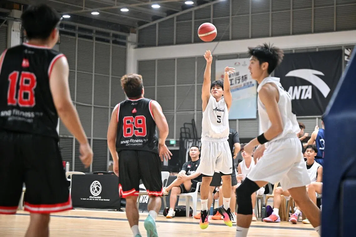 Adroit players (in white) in their first National Basketball League Division 2 game this season against Sin Kee at Singapore Basketball Centre on Oct 24.
