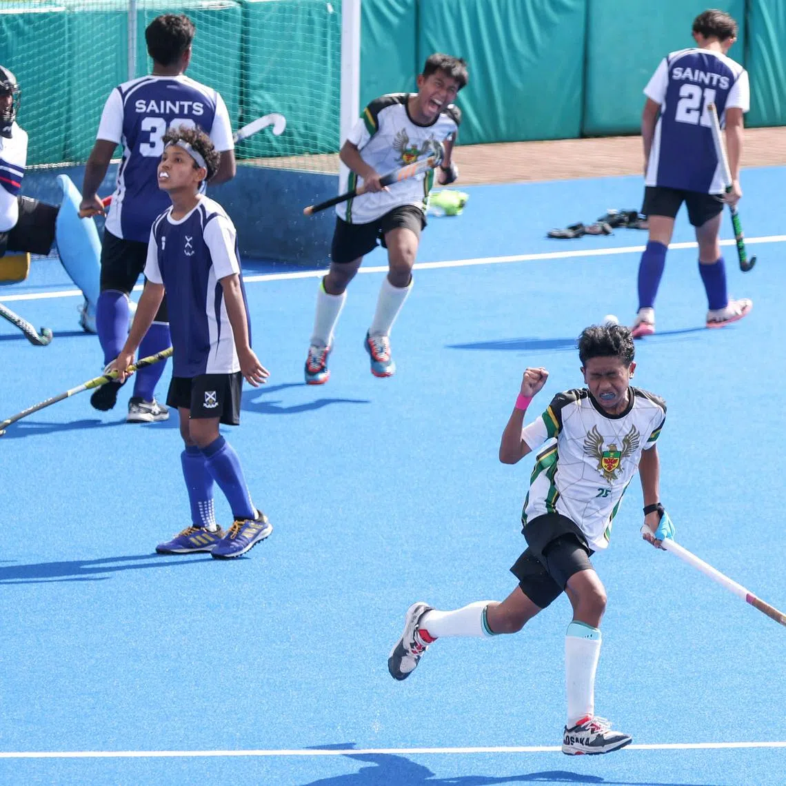 Raffles Institution's Alif Ayden Aidil Sharil (right) scored the winner in both his C and B division finals.