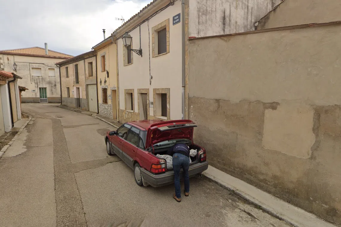 An image captured by a Google Street View vehicle shows a man hunched over the trunk of a car in the northern Spanish province of Soria.