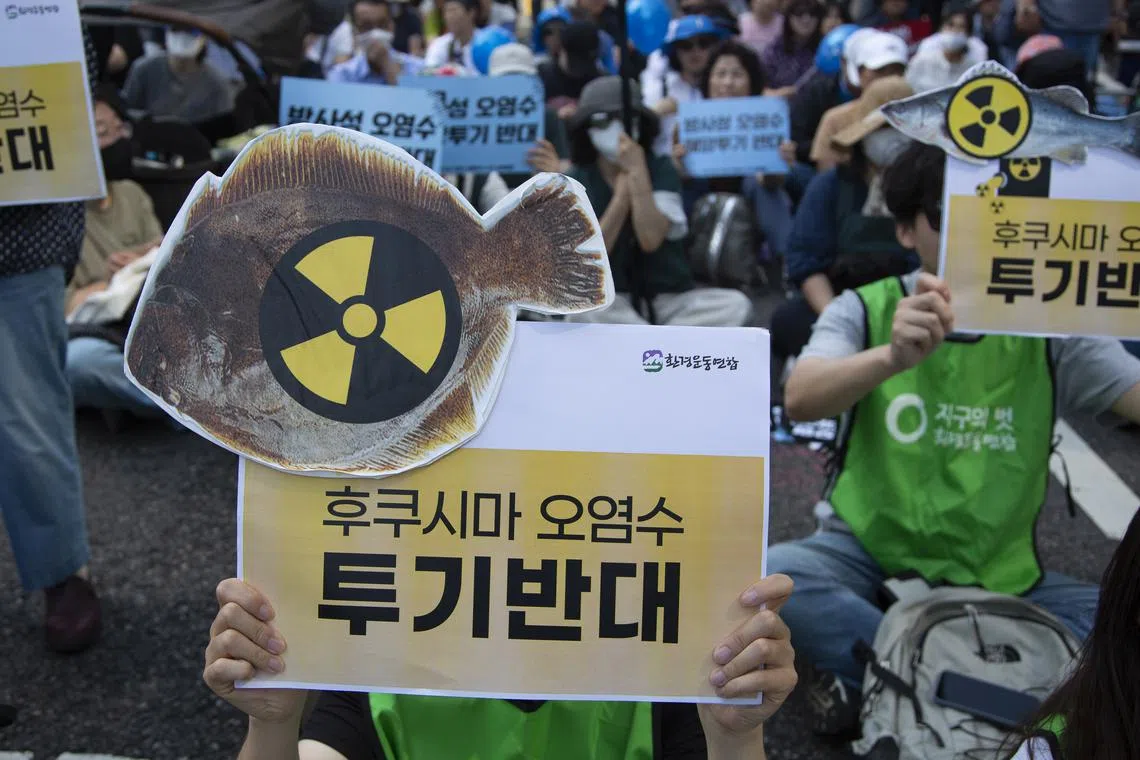 Protestors hold banners reading 'No, Fukushima radioactive water' during a rally in Seoul, on May 20, 2023. 