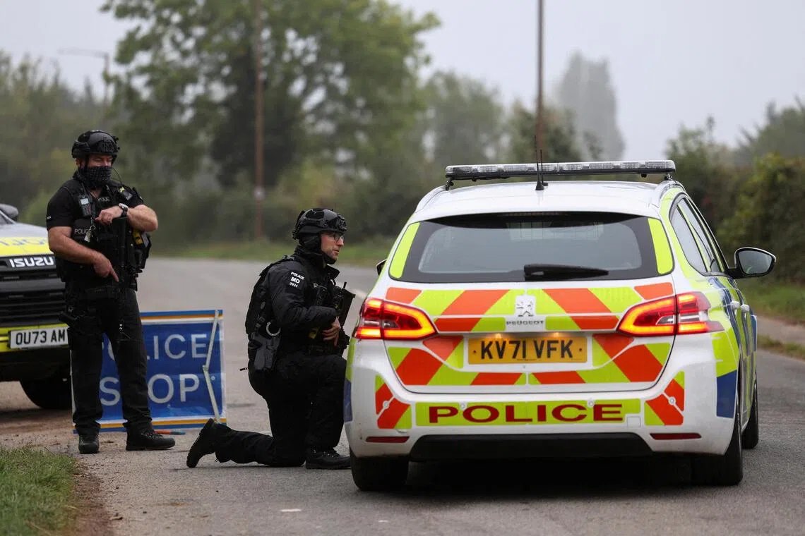 Police officers on guard near Britain’s RAF Fairford airbase, in Fairford, Gloucestershire, on Sept 29.