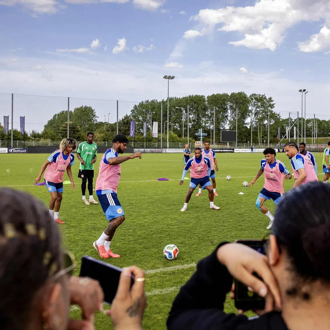 Supporters watch Curacao's players practising during a training session.