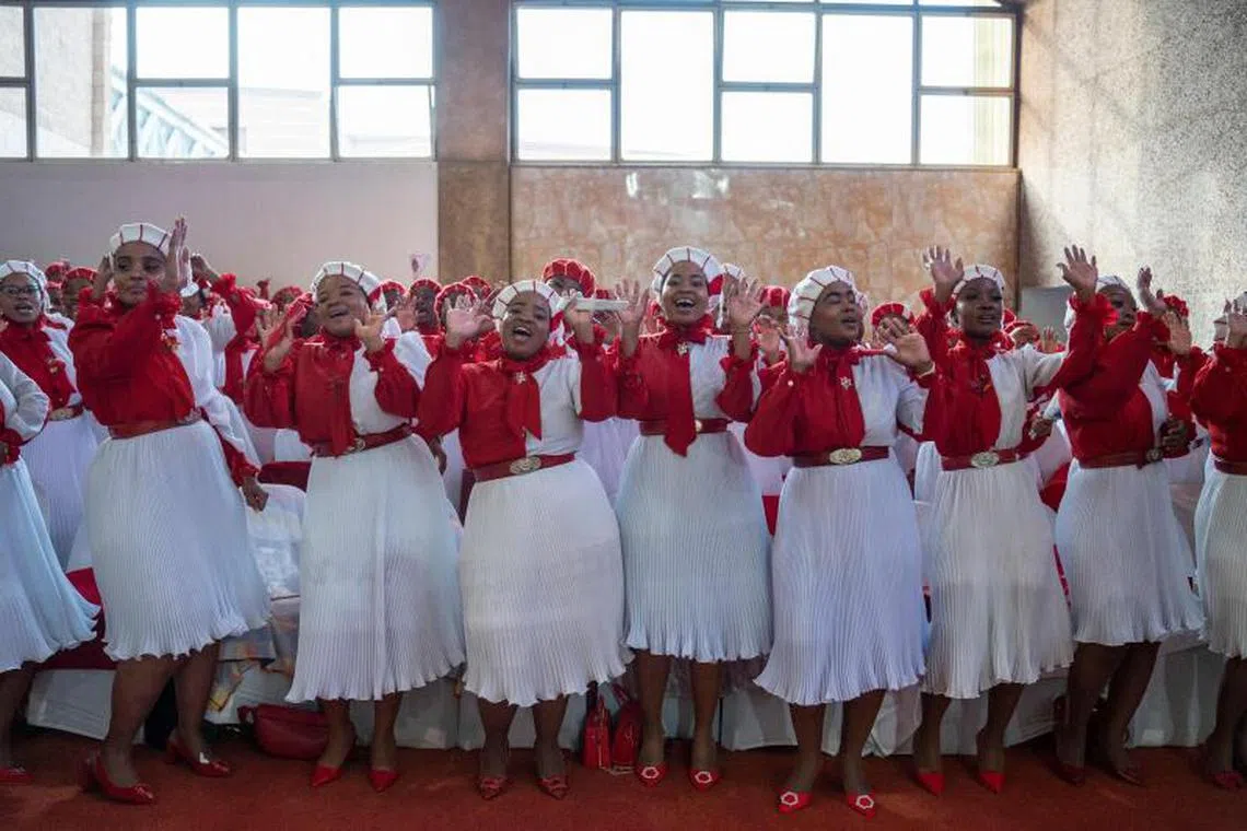 Worshippers sing and dance at the International Pentecostal Holiness Church in Zuurbekom, south of Johannesburg, ahead of a mass wedding ceremony where 80 couples got married during the Easter Sunday service on April 9, 2023. 