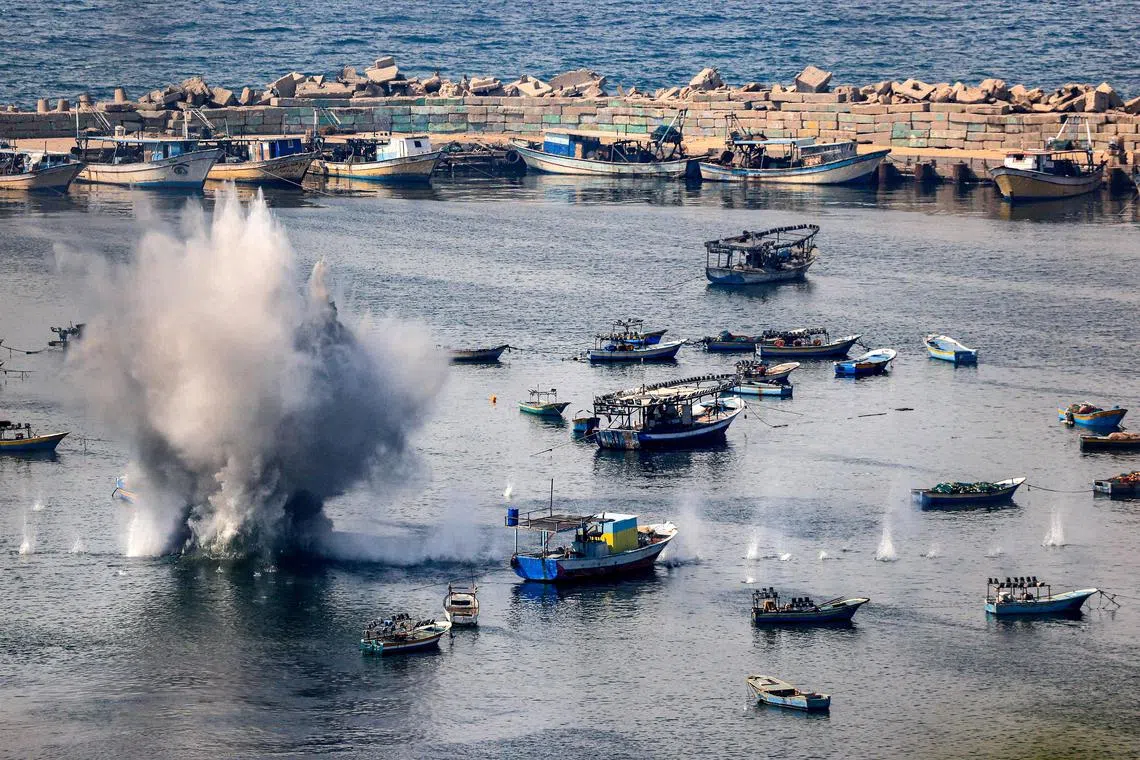 Shells from Israeli bombardment landing in the water in the Gaza City seaport on Oct 11, on the fifth day of ferocious fighting between Hamas and Israel.