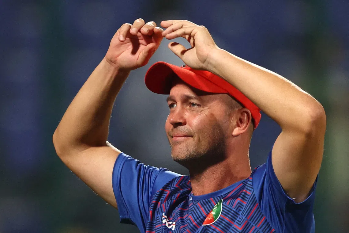 Cricket - ICC Cricket World Cup 2023 - England v Afghanistan - Arun Jaitley Stadium, New Delhi, India - October 15, 2023 Afghanistan coach Jonathan Trott celebrates after the match REUTERS/Andrew Boyers