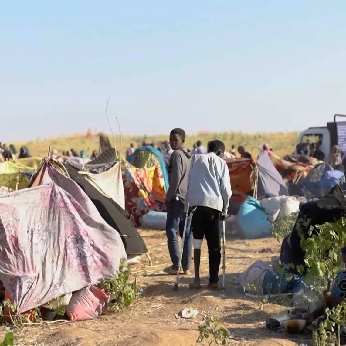 Displaced Sudanese gather and sit in makeshift tents after fleeing Al-Fashir city in Darfur, in Tawila, Sudan, on Oct 29.