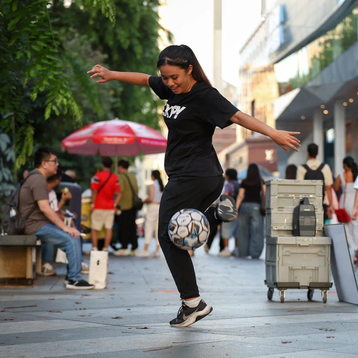 Freestyle footballer Valerie Su busking outside Wisma Atria on July 17.