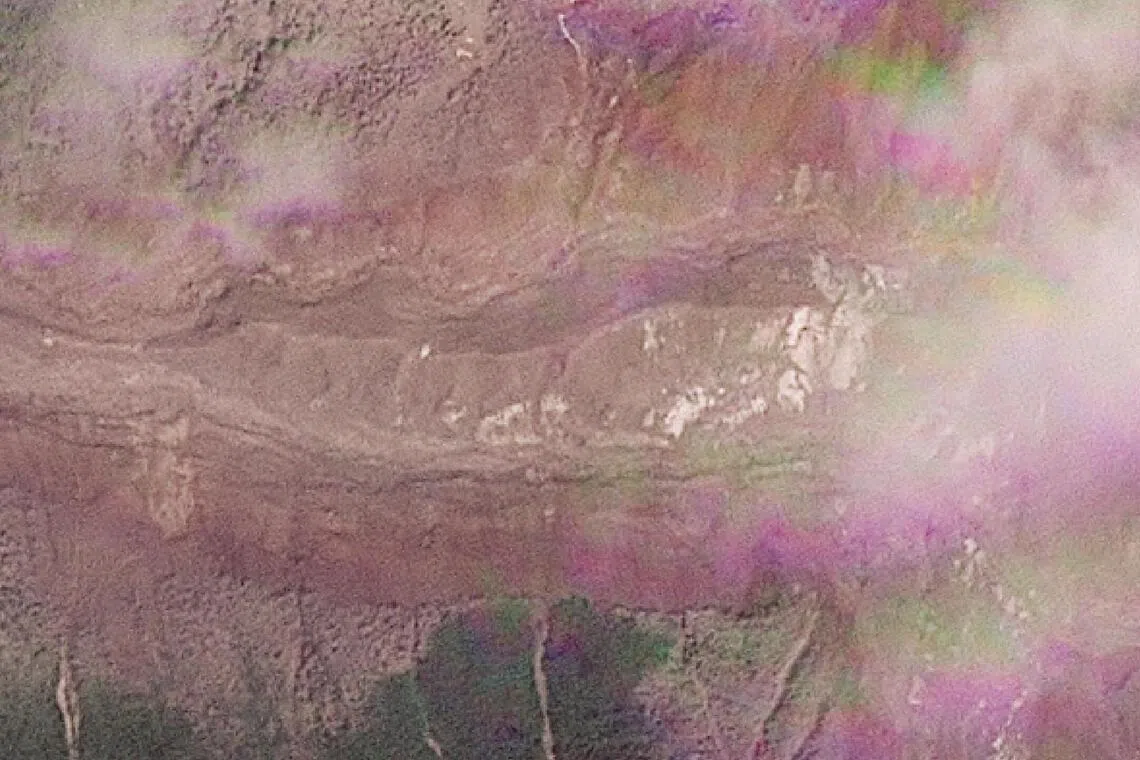 A satellite view shows a lake building up where a glacier collapse set off a deadly cascade of ice, mud and debris.