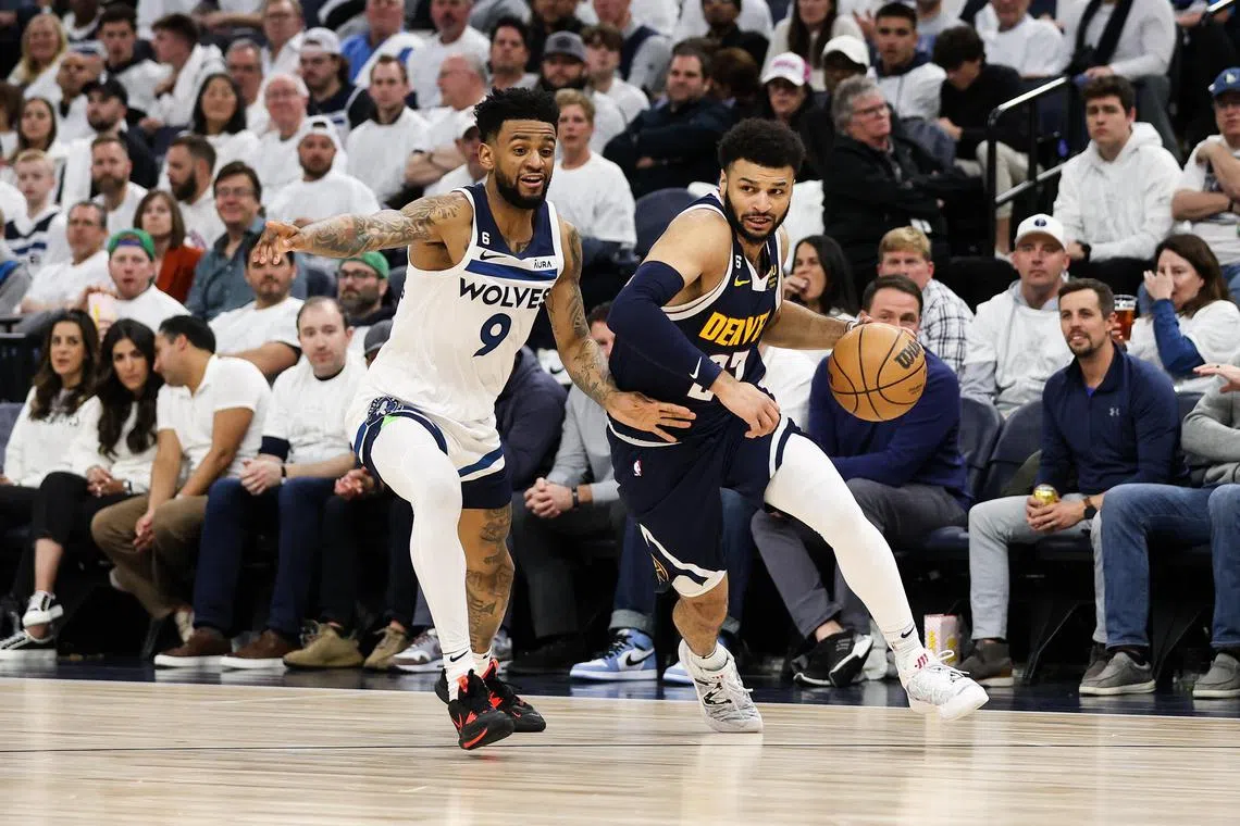 Apr 23, 2023; Minneapolis, Minnesota, USA; Denver Nuggets guard Jamal Murray (27) drives while Minnesota Timberwolves guard Nickeil Alexander-Walker (9) defends during the second quarter of game four of the 2023 NBA Playoffs at Target Center. Mandatory Credit: Matt Krohn-USA TODAY Sports