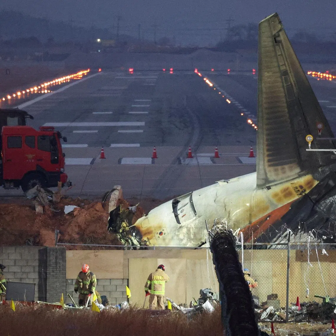 Rescuers work near the wreckage of the Jeju Air aircraft that went off the runway and crashed at Muan International Airport, in Muan, South Korea, December 30, 2024. REUTERS/Kim Hong-Ji/File Photo