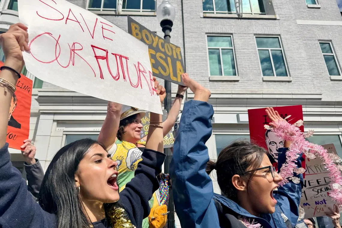 Anti-Musk protesters gather outside Tesla dealership in Washington ...