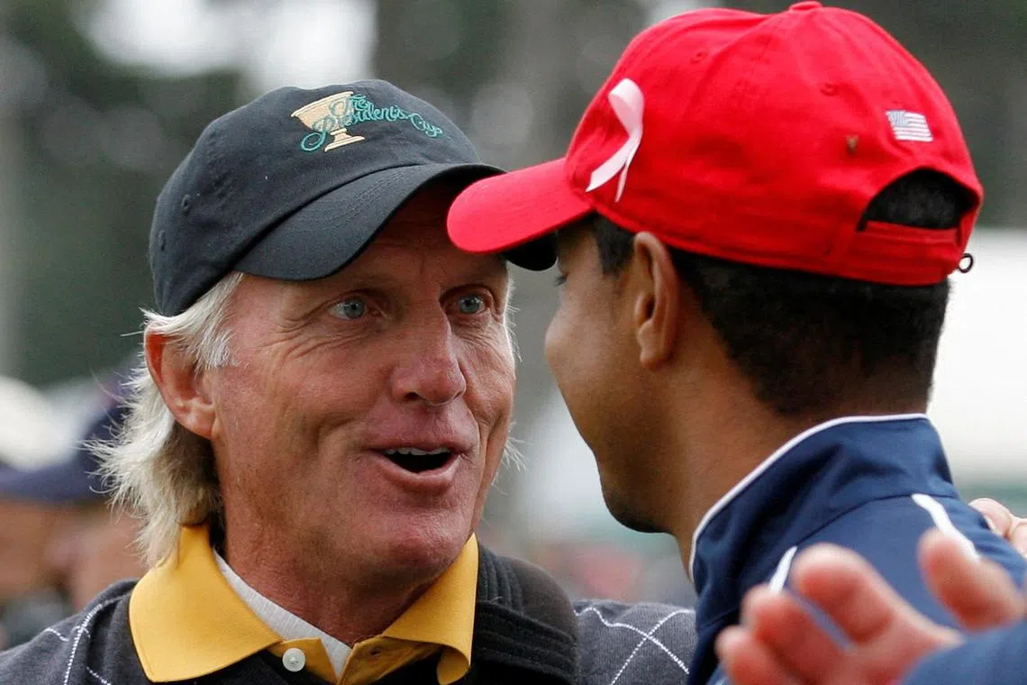 In happier days, at the 2009 Presidents Cup, International team captain Greg Norman chatting with US team member Tiger Woods.
