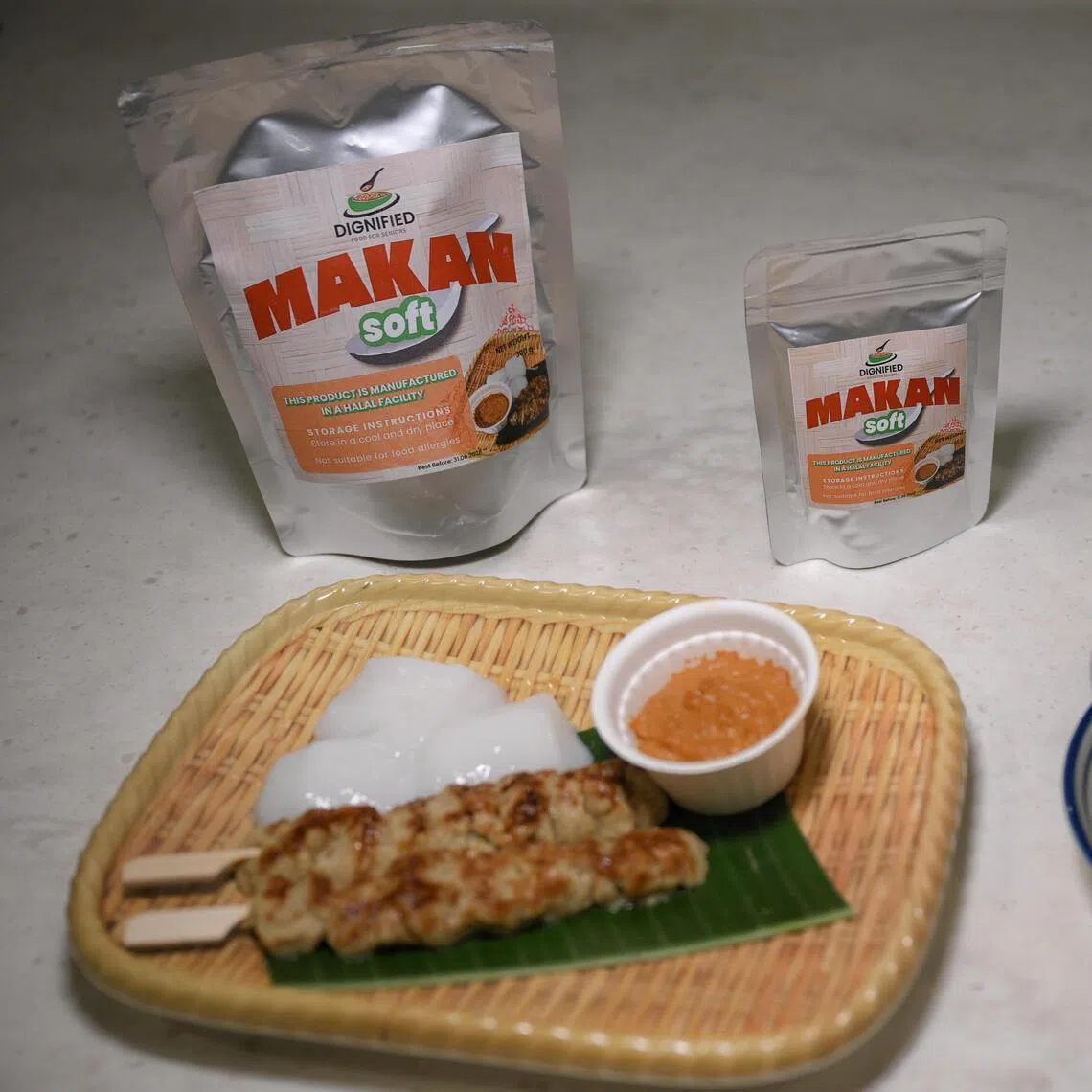 Satay, ketupat and satay sauce (left), and Curry fishballs (right) using Makan Soft powder (background) to make. Makan Soft powder is an ingredient to be added into the food to adjust the texture during the preparation process to created molded foods suitable for chewing and swallowing problem.