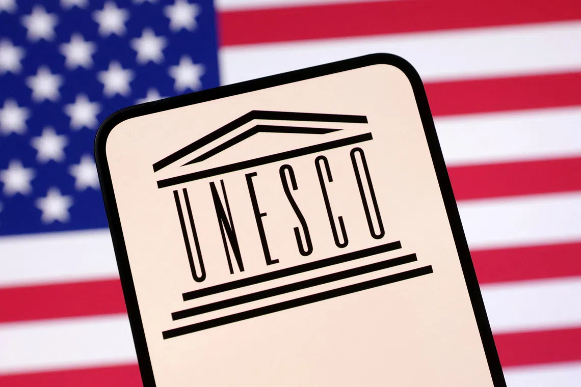 UNESCO logo and U.S. flag are seen in this illustration taken April 23, 2025. REUTERS/Dado Ruvic/Illustration