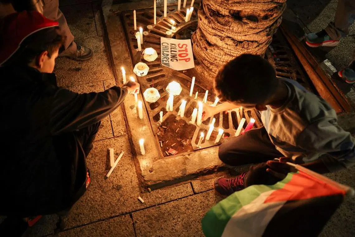 Children light candles during a candlelight vigil in support of Palestinians in Gaza, amid the ongoing conflict between Israel and the Palestinian Islamist group Hamas, in Beirut, Lebanon, November 10, 2023. REUTERS/Esa Alexander/File Photo