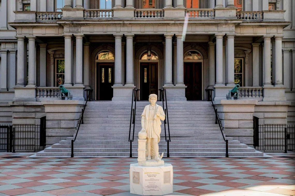 A statue of Christopher Columbus stands in front of the Eisenhower Executive Office Building at the White House Complex in Washington after being installed early on March 22.