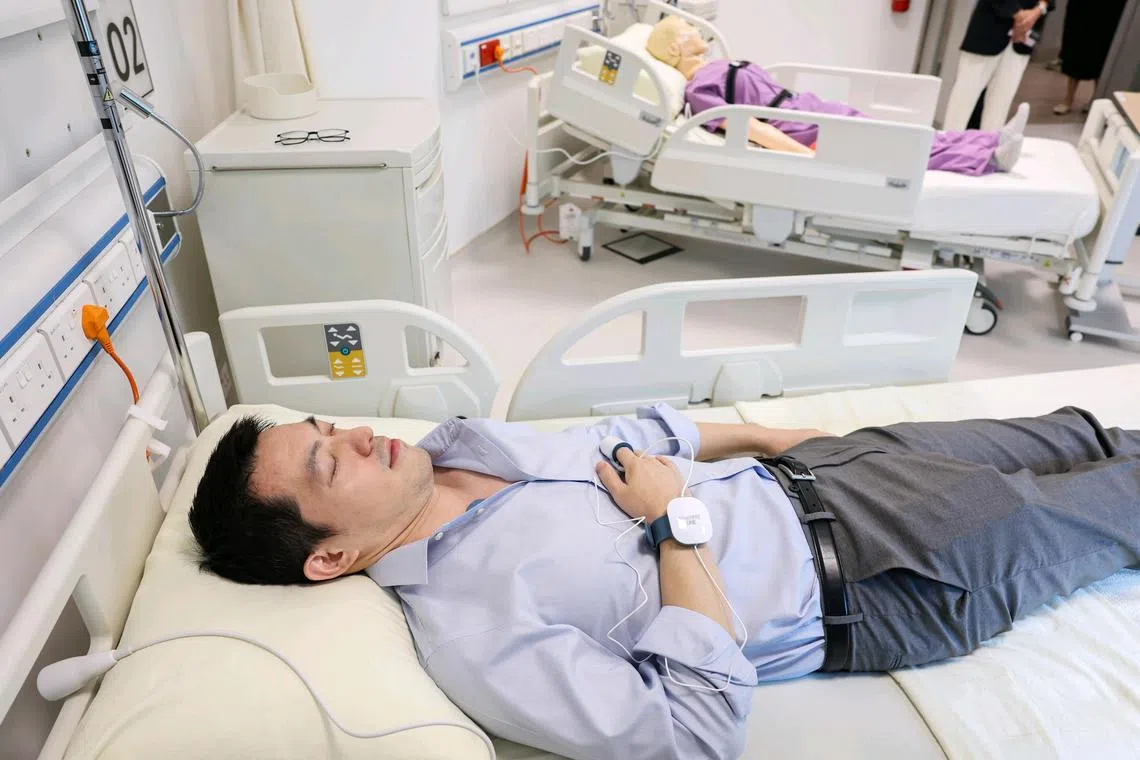 ST20241114_202464000986/oclilly14/Brian Teo/Osmond Chia Quan En/Mr Liheng Tao, 41, Lilly data manager, demonstrating the new sleep monitoring device in the study room at Lilly's new Digital Health Innovation Hub at the Synapse building in Biopolis on Nov 14, 2024. ST PHOTO: BRIAN TEO