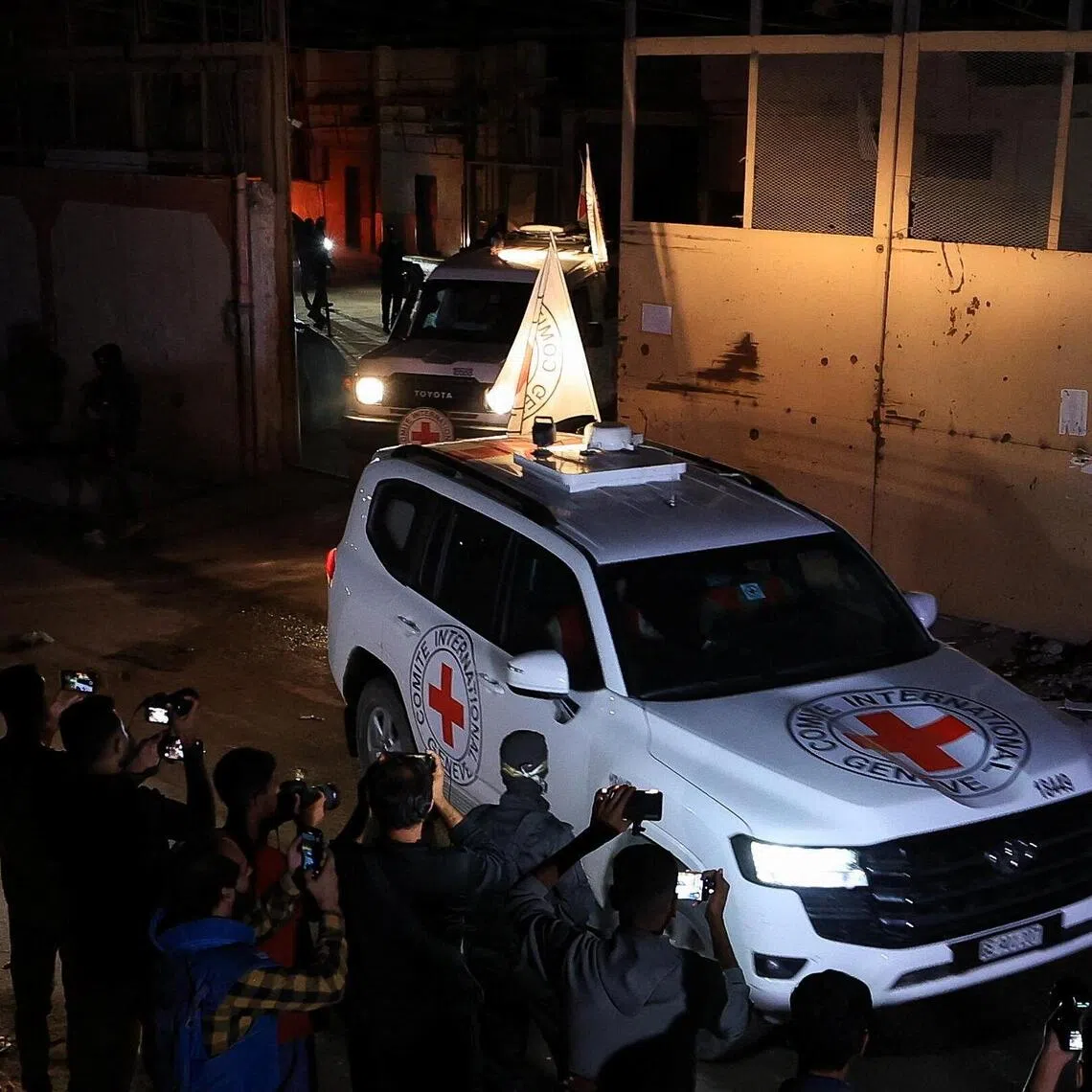 Red Cross vehicles transport the bodies of deceased hostages after they were handed over by Hamas militants as part of a ceasefire and a hostages-prisoners swap deal between Hamas and Israel.
