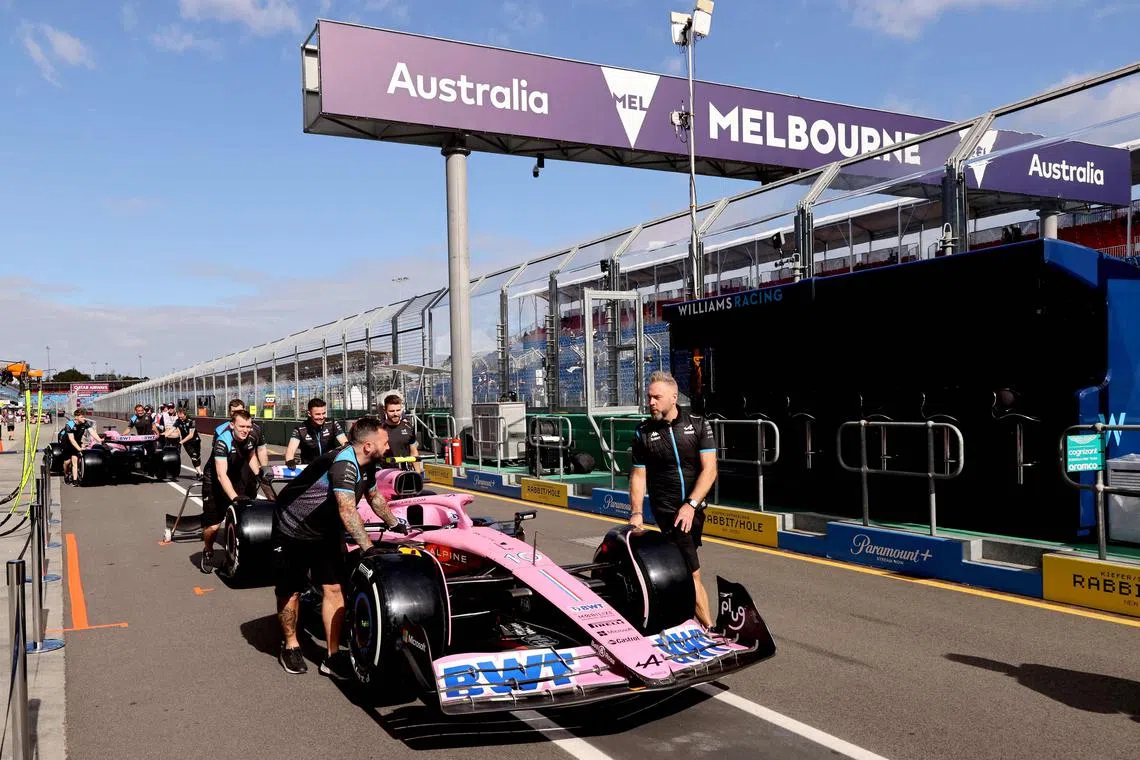 Mechanics with Formula One cars in the pitlane on March 30, 2023 ahead of the Australian Grand Prix on April 2.