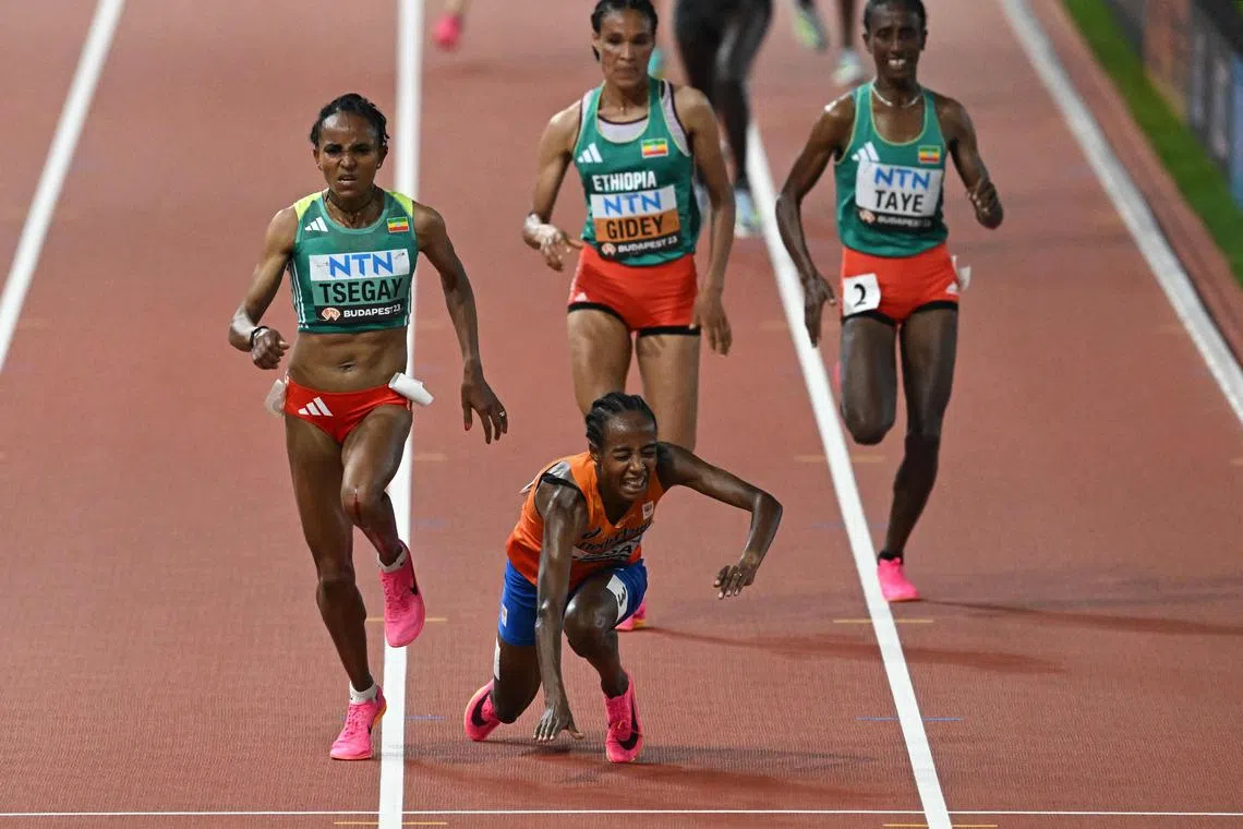 Netherlands' Sifan Hassan falls while running past Ethiopia's Gudaf Tsegay, Letesenbet Gidey, and Ejgayehu Taye in the women's 10,000m final.