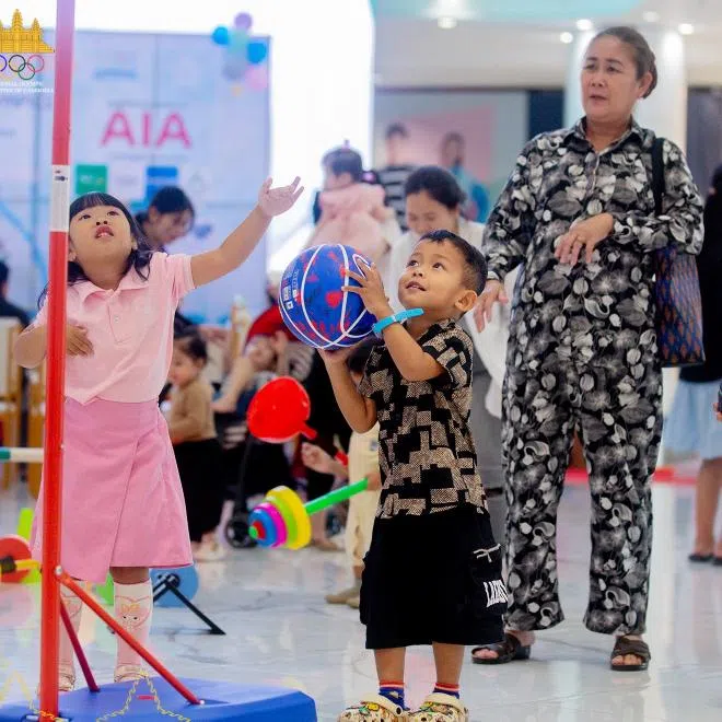 Children trying out sports on the sidelines of a press conference announcing the first "Baby Olympics" in Cambodia on Jan 24.
