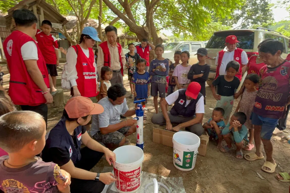 SRC Volunteers demonstrating use of walter filters to affected communities in Laos.