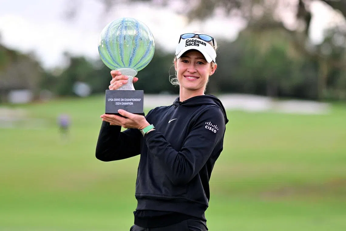 Nelly Korda of the United States posing with the championship trophy after a victory on the second play-off hole at the LPGA Drive On Championship.