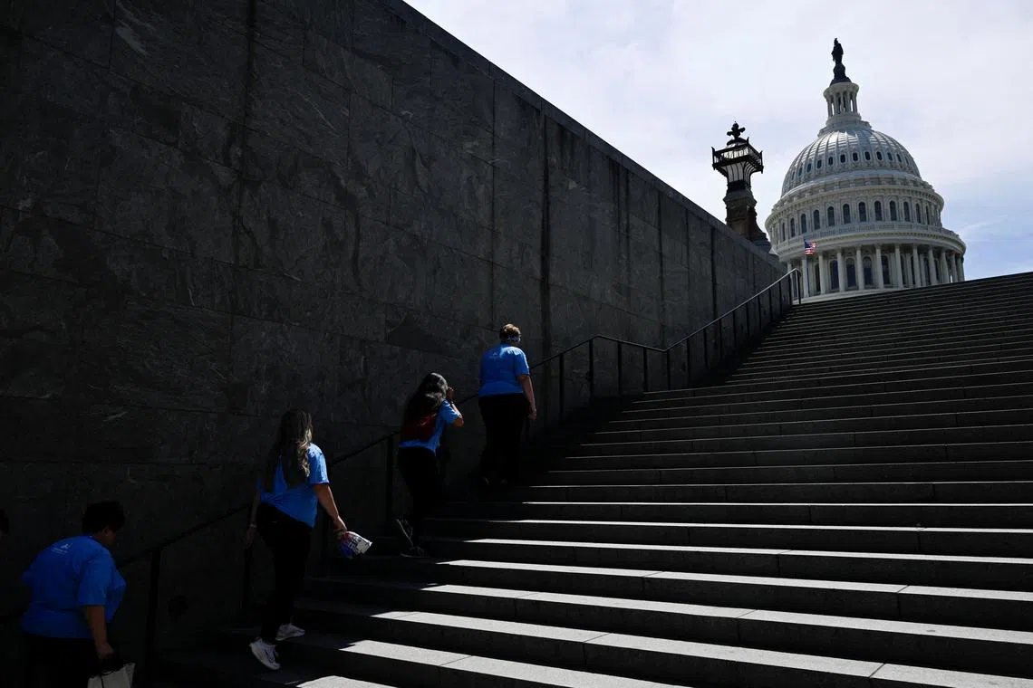 Visitors ascending the last remaining part of shade of a set of stairs on Capitol Hill, amid a heatwave in Washington, U.S., on June 19, 2024. 