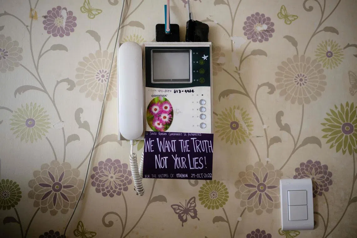 A card that reads "we want the truth not your lies!" is displayed below an intercom phone at the family home of Lee Ji-han who was killed aged 24 during a Halloween crowd crush in the popular Itaewon district in October last year.