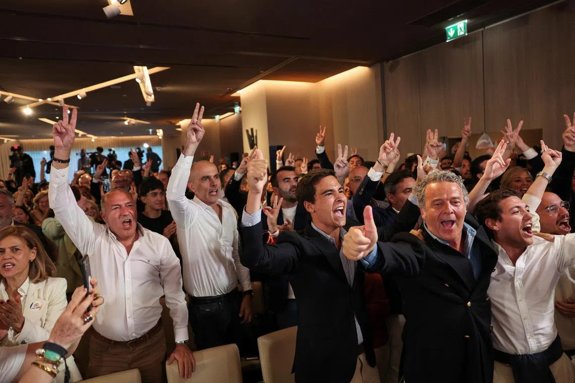 Supporters react to first electoral result projections at Portugal's Social Democratic Party (PSD) and Democratic Alliance (AD) leader Luis Montenegro's electoral night headquarters, in Lisbon, Portugal.