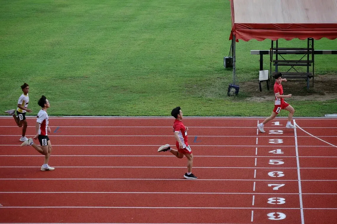 Ezra Lim (right) of Fuhua Secondary School in action for the men's U16 100m timed finals of the West Zone Athletics Meet 2026 at Hwa Chong Institution on Oct 26, 2026.
