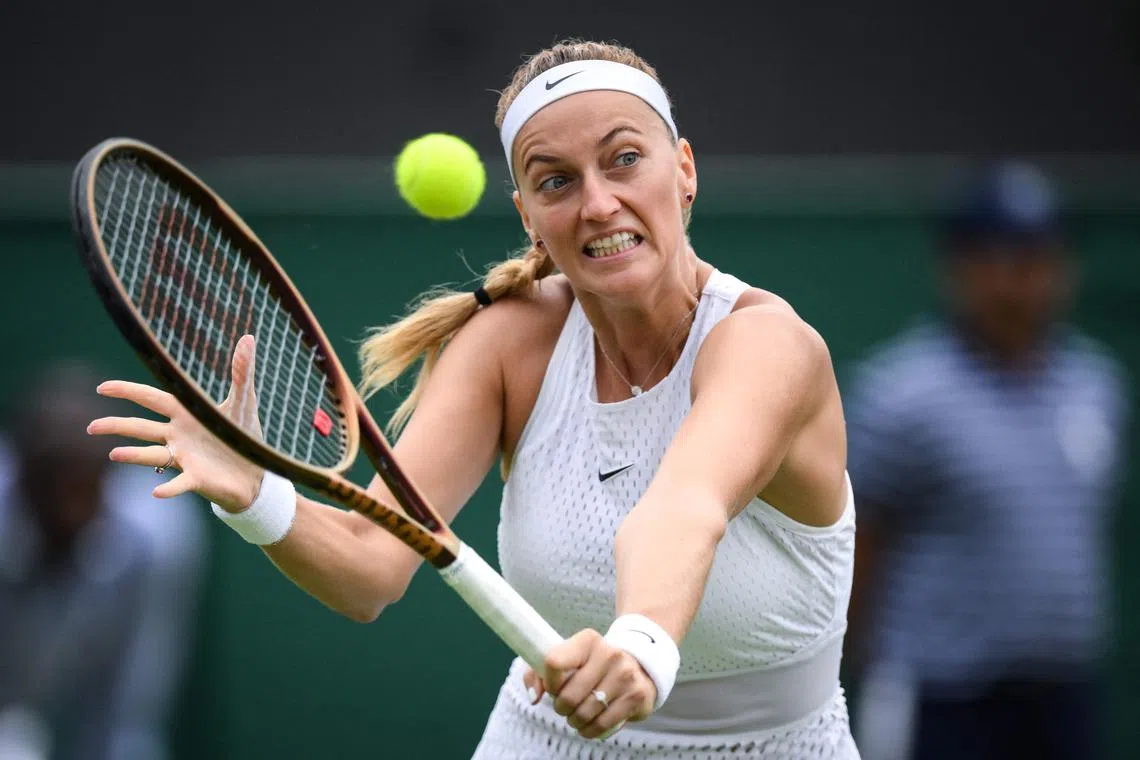 Czech Republic's Petra Kvitova returning the ball to Natalija Stevanovic of Serbia during their Wimbledon third-round clash.
