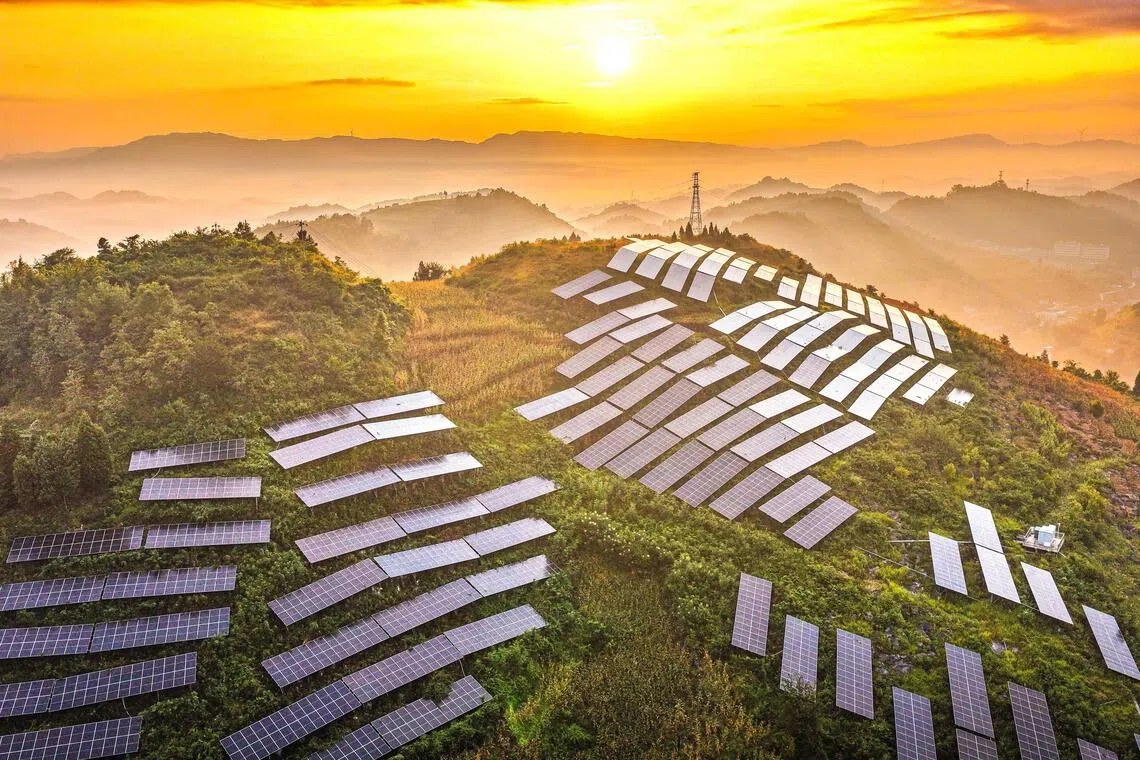 TOPSHOT - Solar panels are arranged on a hillside at an agricultural photovoltaic power station in Dingxin Yi and Miao Ethnic Township, Qianxi City, in southwestern China's Guizhou province, on August 17, 2026. (Photo by CN-STR / AFP) / China OUT