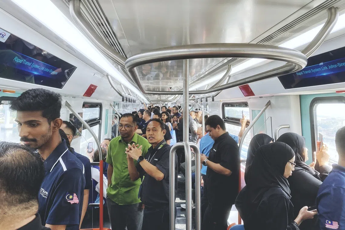 Members of the media and invited officials on board an RTS Link train on a test return trip between Bukit Chagar and Woodlands on Aug 18.