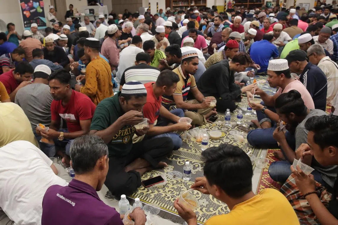 Muslim devotees breaking fast at 7.16pm on the first day of Ramadan at Khalid Mosque on March 23.