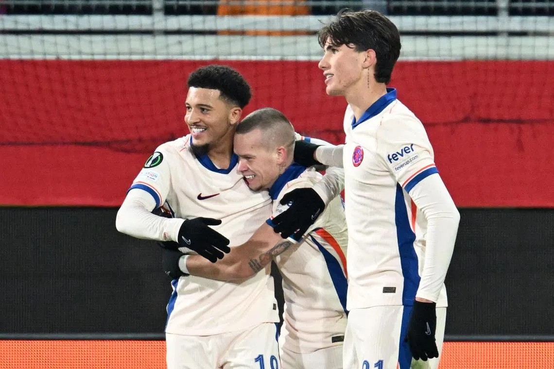 Chelsea's Mykhailo Mudryk celebrates scoring their second goal with Jadon Sancho and Cesare Casadei.