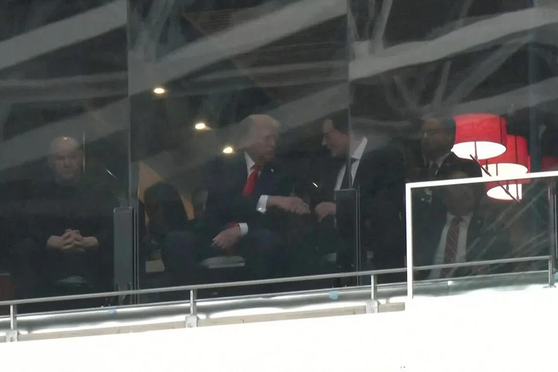 A still image from video shows US President Donald Trump and Tesla CEO Elon Musk shaking hands in a skybox at State Farm Stadium during the memorial service for slain conservative commentator Charlie Kirk, in Glendale, Arizona on Sept 21. 