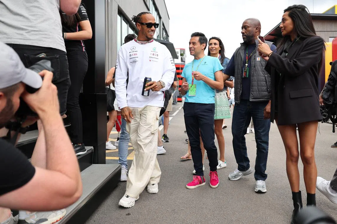 Mercedes' Lewis Hamilton (left) arrives at his team's motorhome ahead of the Spanish grand prix weekend.