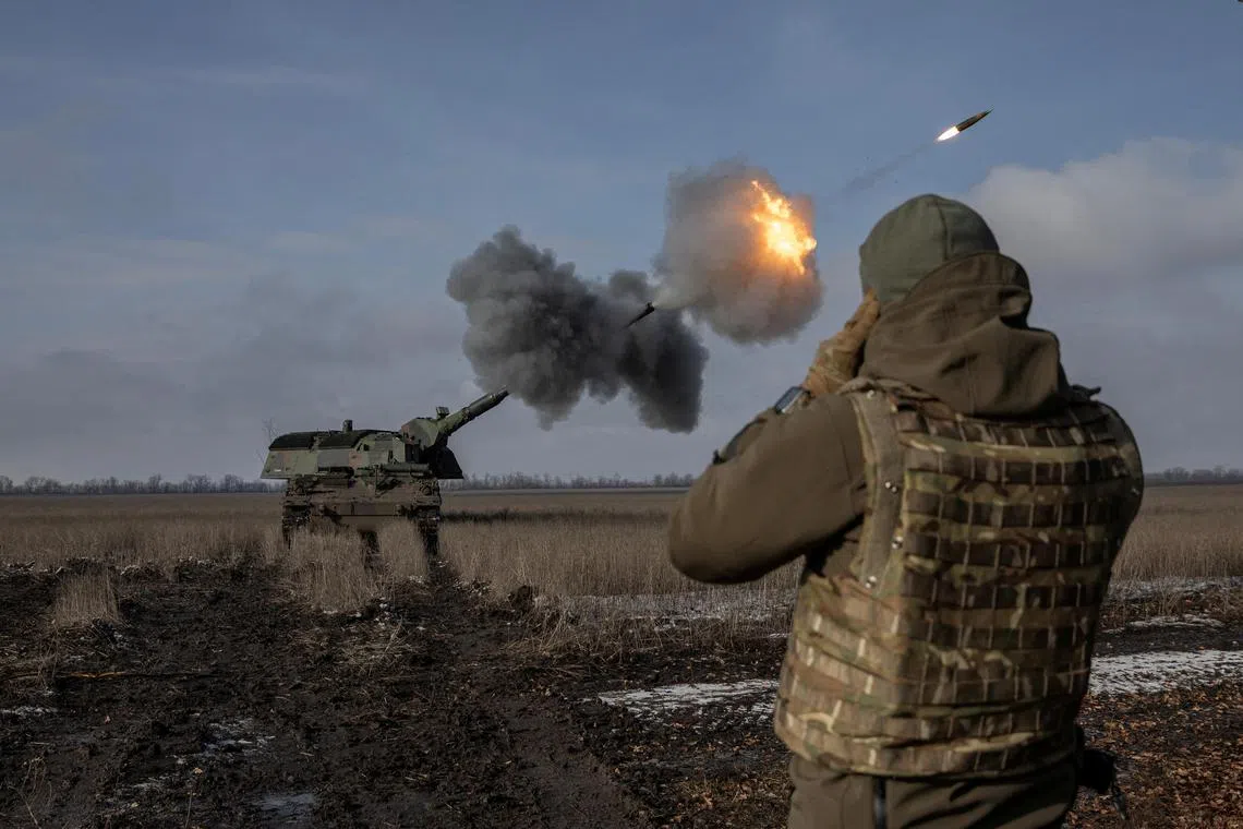 Ukrainian soldiers fire a German howitzer near Bakhmut, in Ukraine's Donetsk region, on Feb 5, 2023.