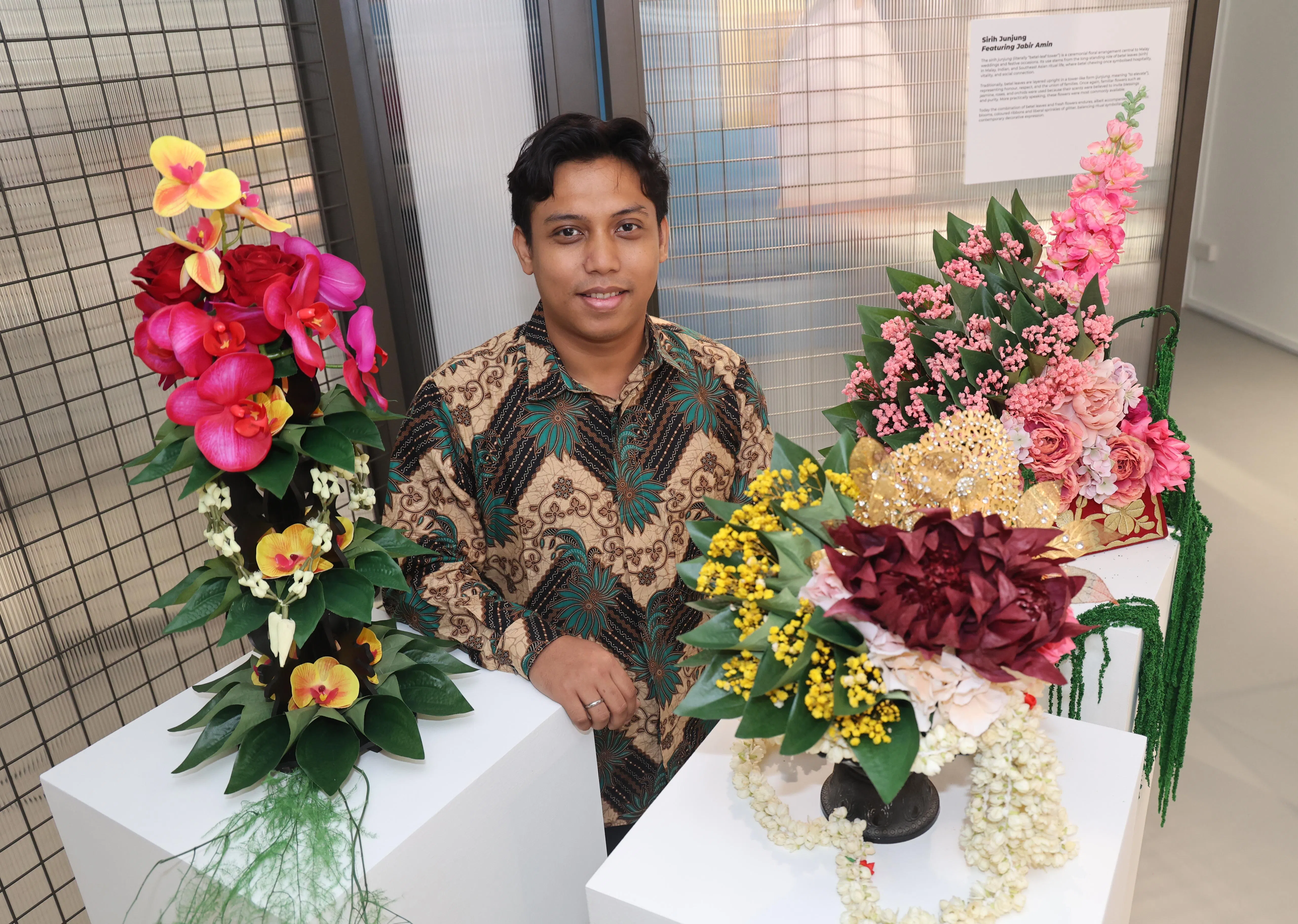 Freelance wedding stylist Jabir Amin with three floral arrangements called sirih junjung (left and right) and sirih dara (centre) that are typically exchanged in Malay weddings.
