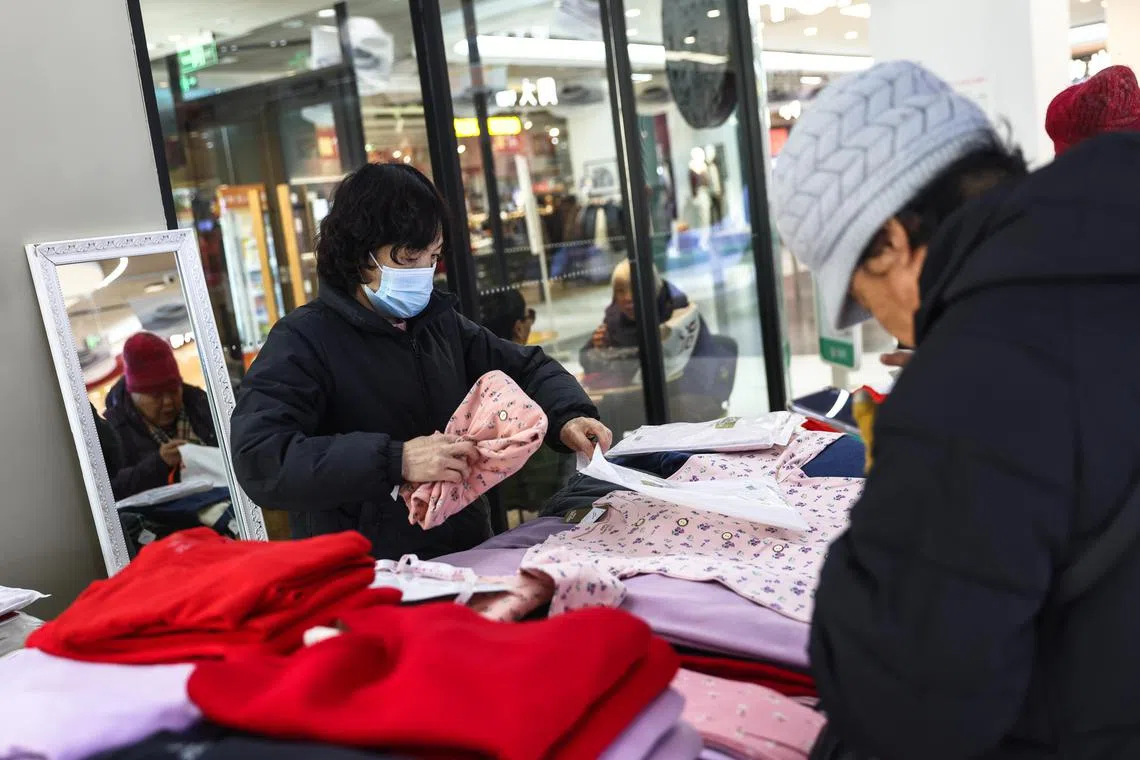 Shoppers at a clothing shop in Beijing, China on Dec 16, 2024. 
