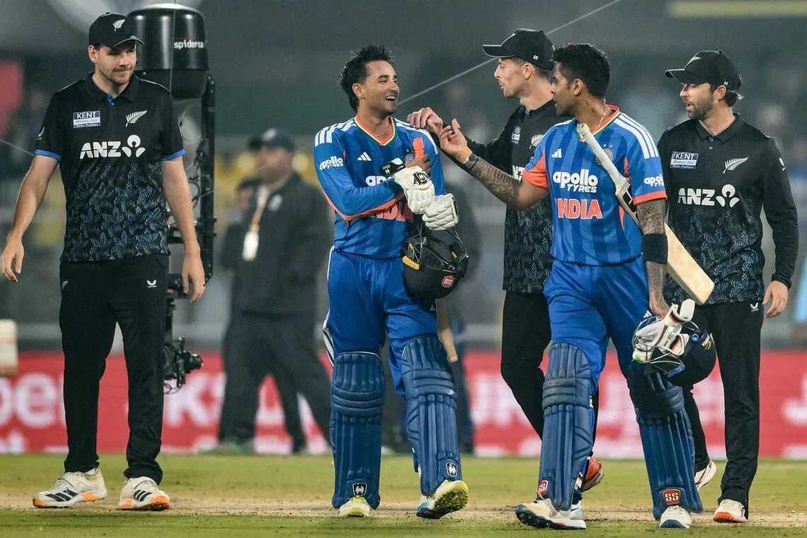 India's Abhishek Sharma (wearing gloves) and captain Suryakumar Yadav walk back to the pavilion after their team's win over  New Zealand in the third Twenty20 international at the Barsapara Cricket Stadium in Guwahati on Jan 25, 2026.