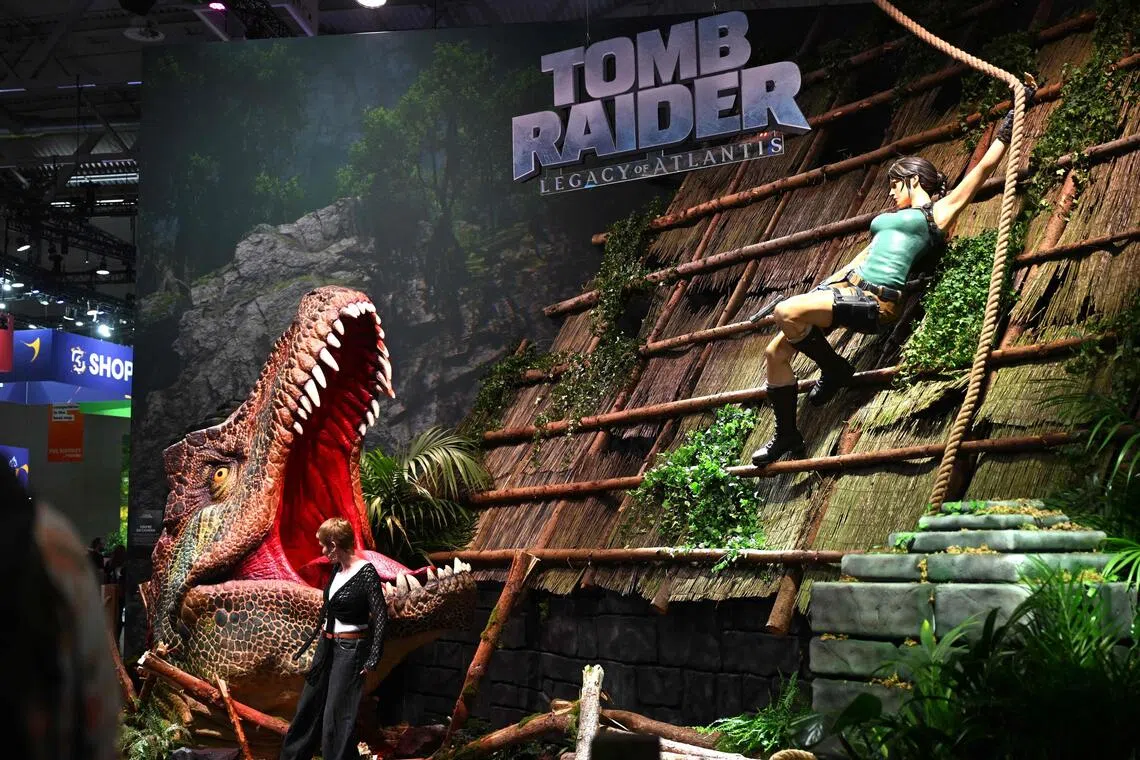 A visitor poses at the Tomb Raider: Legacy of Atlantis video game at Gamescom in Cologne, Germany on Aug 26.