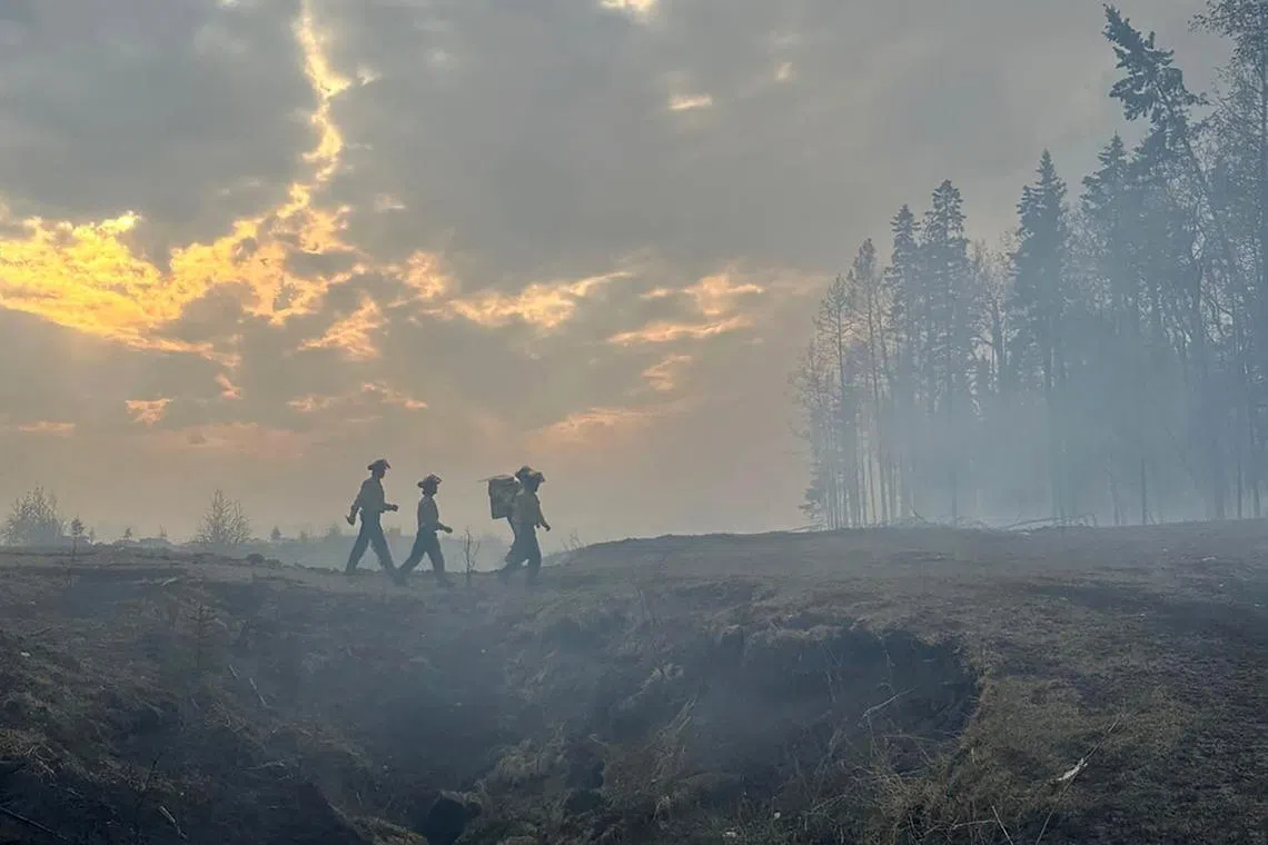 Firefighters returning to retrieve more gear while tackling the Deep Creek Wildfire Complex near Entwistle, Alberta, Canada May 15.