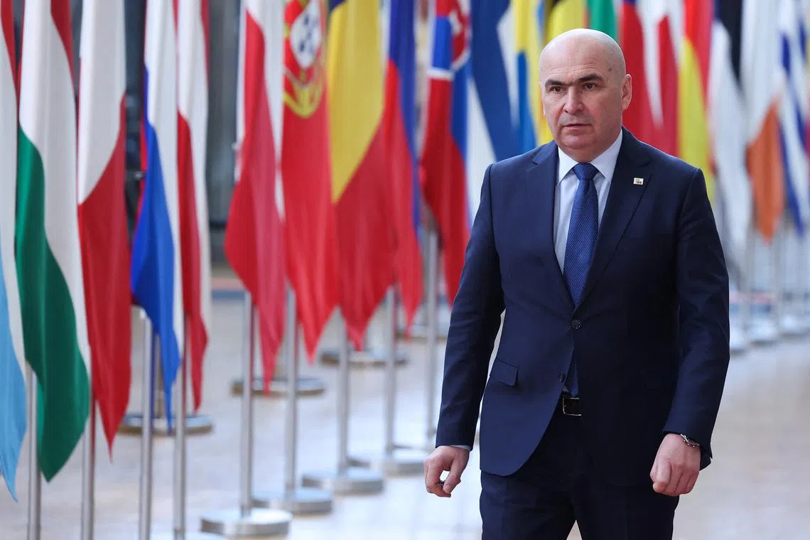 FILE PHOTO: Romania's Ilie Bolojan walks to attend a European Union summit in Brussels, Belgium March 20, 2025. REUTERS/Yves Herman/ File Photo