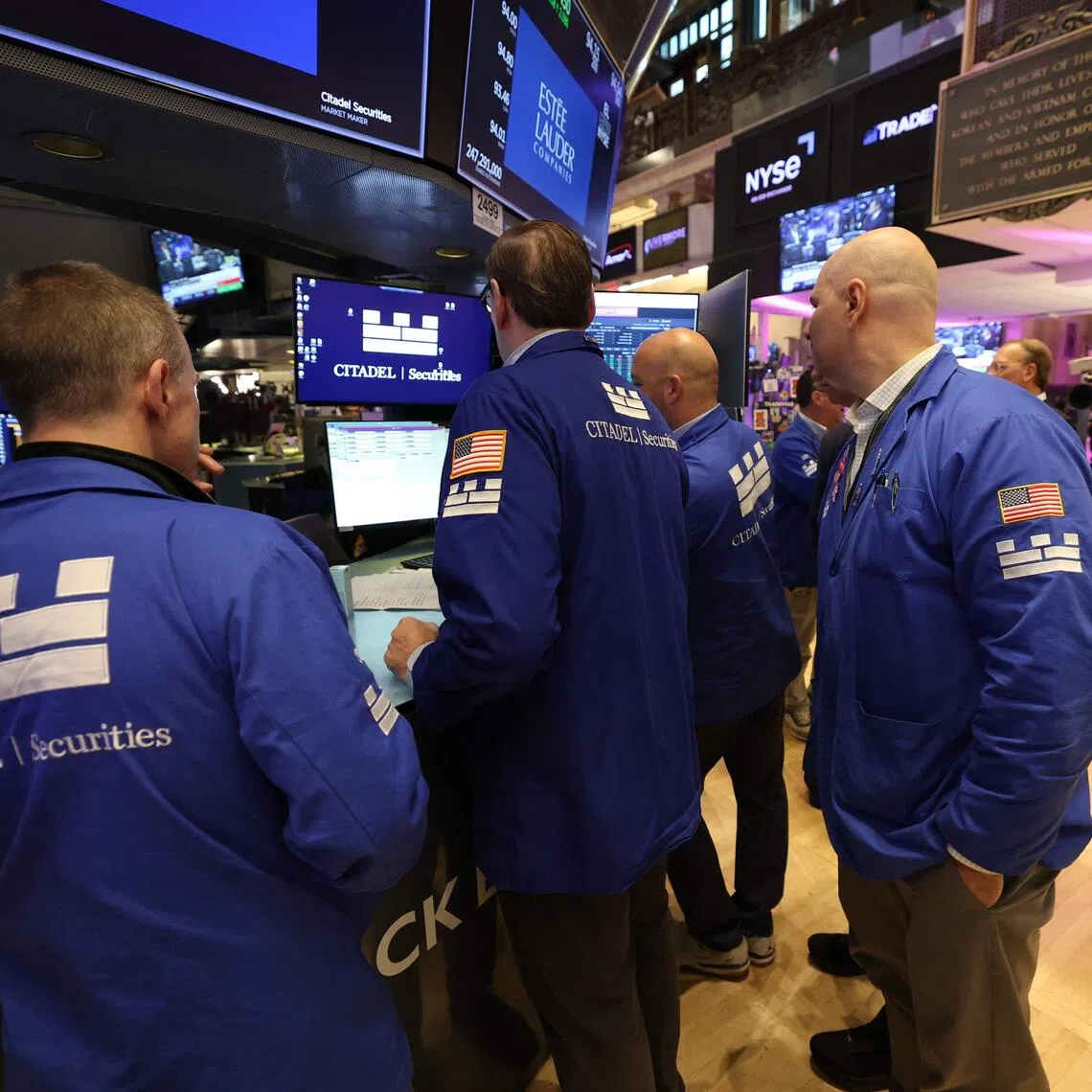 Traders work on the floor of the New York Stock Exchange at the opening bell on Oct 5 in New York City.